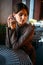 Adorable dark-haired girl sitting in cafe