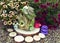 Adorable dollhouse with petunia flowers in the garden