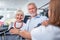 Adorable elderly couple in front of cashier desk