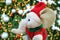 Adorable Elephant doll with Santa Hat in front of Glittering Christmas Tree