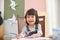 Adorable ethnic girl with colorful pencils