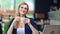 Adorable European business female in glasses holding coffee cup enjoying break at cafe medium shot