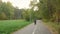 Adorable excited teenage boy cycling bike in autumn park