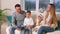 Adorable family, father reading a book to their family sitting in living room.