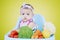 Adorable female baby with vegetables