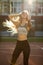 Adorable fitness girl with hair in wind wearing sport apparel, p