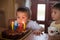 Adorable five year old boy celebrating his birthday and blowing