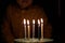 Adorable five year old kid celebrating his birthday and blowing candles on homemade baked cake, indoor. Birthday party for