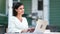 Adorable freelancer young woman working use laptop outdoor. Shot on RED Raven 4k Cinema Camera