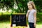 Adorable funny little girl at blackboard practicing counting and math