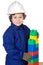 Adorable future builder constructing a brick wall with toy piece