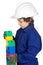 Adorable future builder constructing a brick wall with toy piece