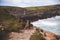 Adorable German Shepherd puppy walking on the rocky cliff