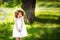 Adorable ginger curly little girl in the summer sunny day