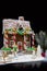 Adorable gingerbread house, sprig of Christmas tree with small g