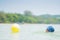 Adorable girl in blue hat swim in ocean near beach. Play with ye