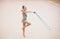 Adorable girl competing in rhythmic gymnastics