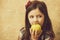 Adorable girl eating vitamin yellow apple