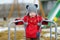 Adorable girl having fun on a playgroud on spring