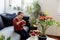 Adorable girl holding fresh apple in her hands sitting on coach at home