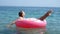 Adorable girl on inflatable air mattress in the sea