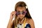 Adorable girl in island style dress peering over her sun glasses