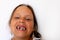 Adorable girl with open toothless mouth with temporary milk crowding teeth in white studio. Dental work with cross bite