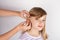 Adorable girl trying a hearing aid