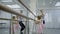 Adorable girls practice with teacher in ballet studio.