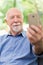 Adorable grandfather taking selfie with his mobile phone