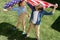 Adorable happy brother and sister waving american flag