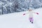 adorable happy child with open arms in mittens running in snow and smiling at camera in winter park