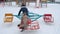 Adorable happy girls having fun with colorful carousel at wintertime
