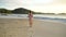 Adorable happy little girl walking on white beach on Caribbean island