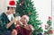 Adorable happy smiling young LGBT couple sharing special moment together on Christmas holiday, Asian gay male lover sitting on