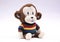 Adorable Happy Stuffed Monkey in Bright Striped Sweater
