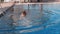 Adorable happy teenage girl swimming in outdoor pool