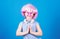 Adorable headset user with praying hands. Small child wearing adjustable white headset and pink hair wig. Little girl