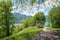 Adorable hiking destination above lake Tegernsee, with gazebo, view through green branches