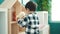 Adorable hispanic boy putting toys on shelving at kindergarten