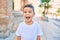 Adorable hispanic boy smiling happy at the city