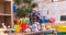 Adorable hispanic boy standing on back view playing at kindergarten