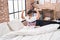 Adorable hispanic boy waking up stretching arms at bedroom