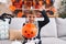 Adorable hispanic boy wearing skeleton costume doing scary gesture at home