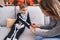 Adorable hispanic boy wearing skeleton costume receiving draw on hand at home