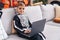 Adorable hispanic boy wearing skeleton costume using laptop at home