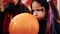 Adorable hispanic girl having halloween party inflating balloon at home
