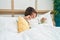 Adorable hispanic girl waking up stretching arms at bedroom