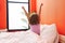 Adorable hispanic girl waking up stretching arms at bedroom