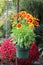 Adorable image of simple green planter and bright,cheerful flowers hanging from metal rod